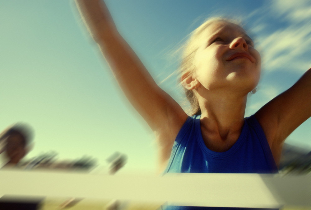 Girl Crossing the Finish Line